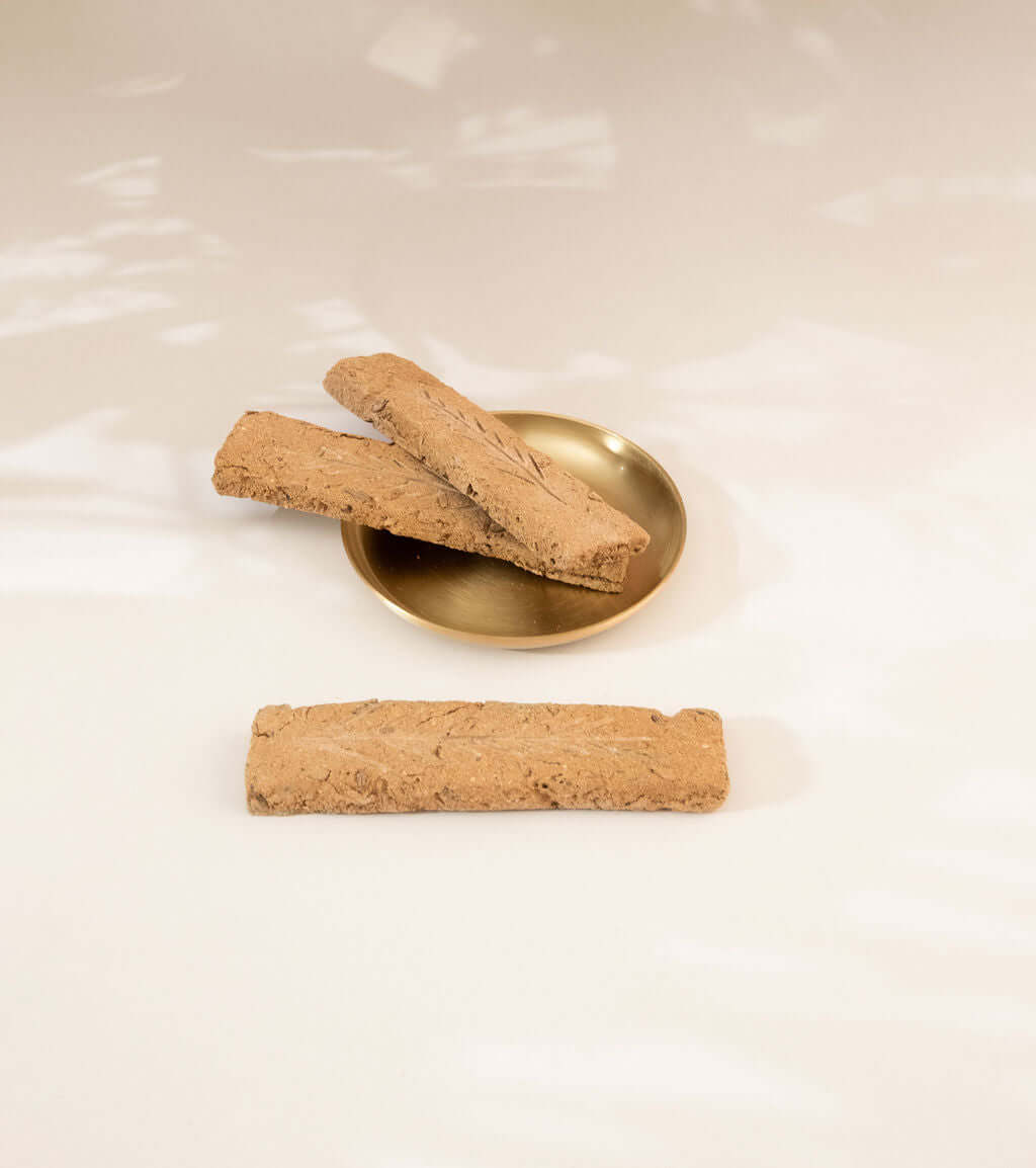 Handcrafted Australian sandalwood incense planks on a gold dish, showcasing premium quality and sustainable ingredients.
