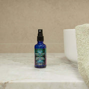 Heart-Opening Cleansing Mist bottle on a marble countertop, featuring premium quality organic ingredients for self-discovery.