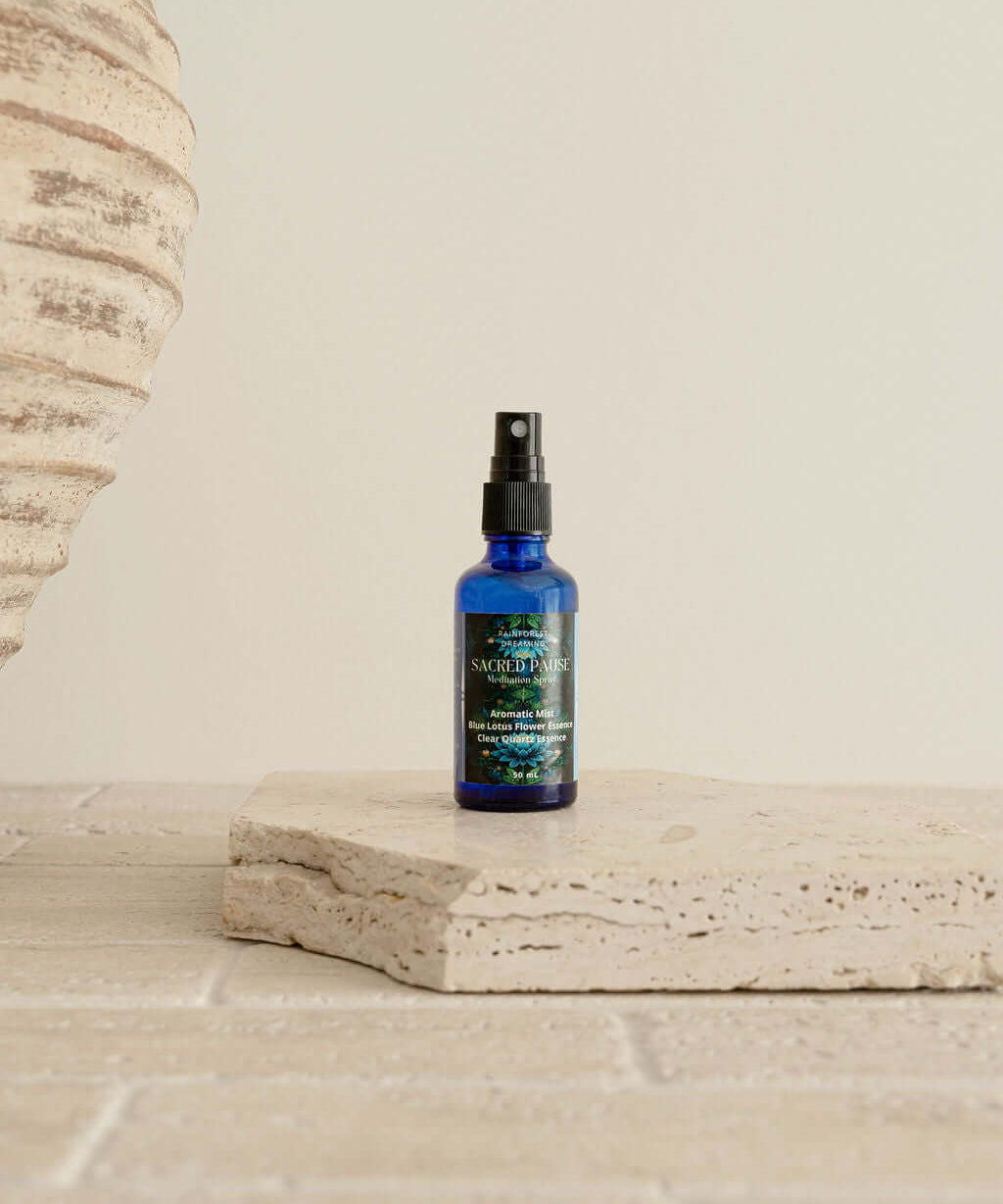 Blue Lotus Meditation Mist bottle on a stone surface, showcasing premium quality for ceremonial cacao experiences.