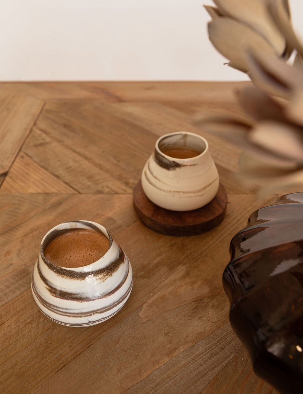 Handcrafted wheel-thrown mini cups for ceremonial cacao, showcasing premium quality and unique artistry by VillageLore Pottery.